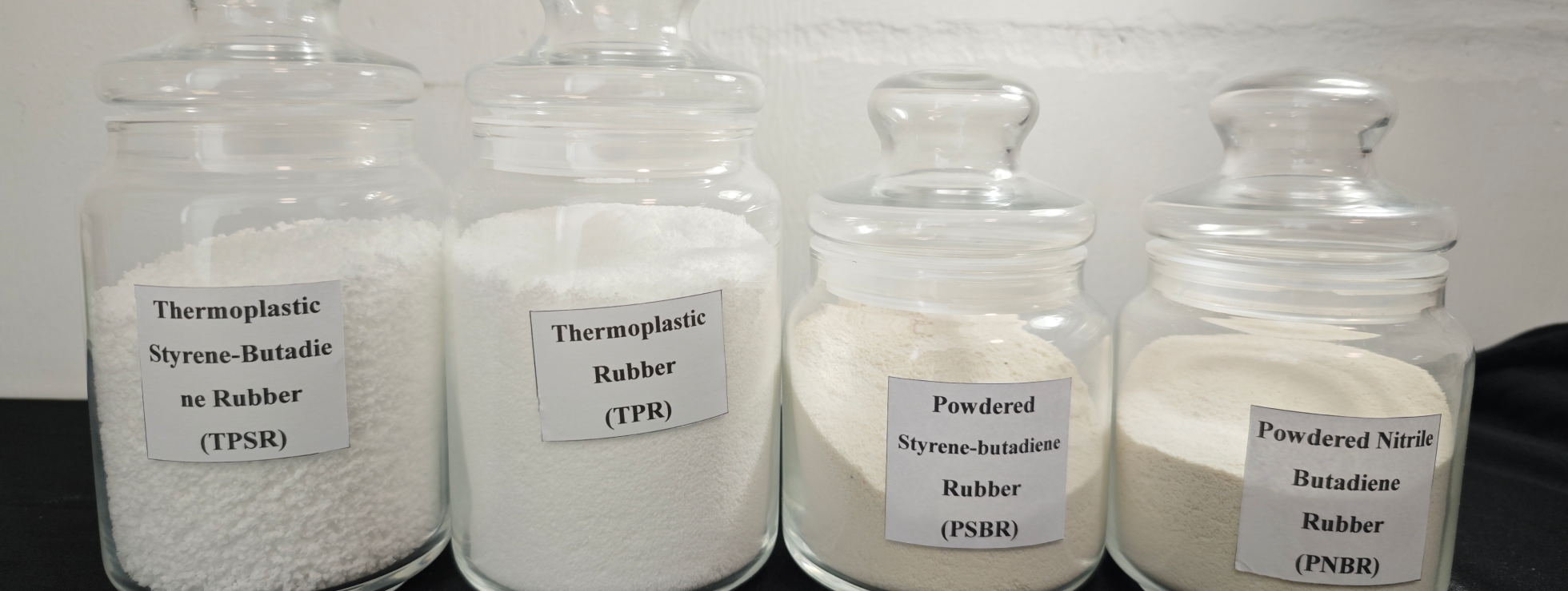 Powder rubber materials in glass jars
