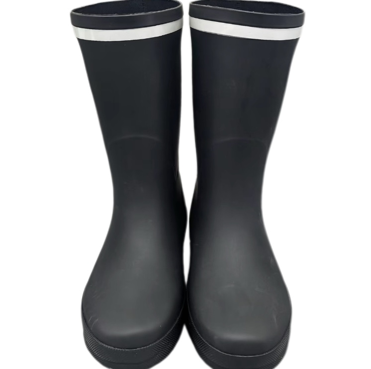 Kids black reflective strip latex rain boots in snowy conditions