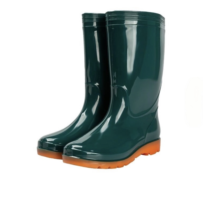 Dark green PVC rain boots with orange anti-slip sole, ideal for muddy hiking trails
